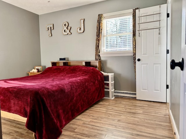 8127 Briery Branch Rd, Dayton, VA 22821 - bedroom with baseboards, baseboard heating, and wood finished floors