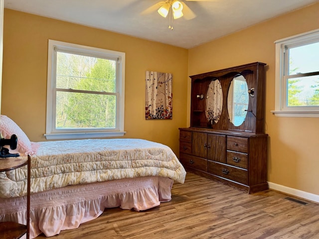 8127 Briery Branch Rd, Dayton, VA 22821 - bedroom featuring visible vents, baseboards, multiple windows, and wood finished floors
