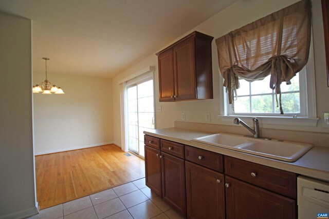 10 Lady Slipper Dr, Waynesboro, VA 22980 - kitchen featuring a sink, a chandelier, light countertops, light tile patterned flooring, and white dishwasher