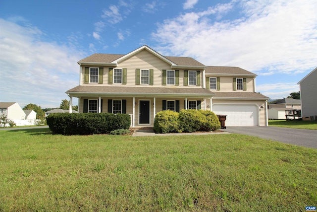 10 Lady Slipper Dr, Waynesboro, VA 22980 - colonial house featuring asphalt driveway, a garage, a front lawn, and covered porch