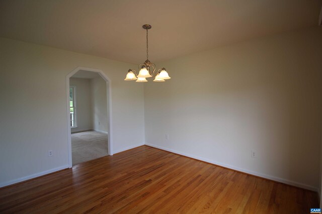 10 Lady Slipper Dr, Waynesboro, VA 22980 - spare room featuring arched walkways, wood finished floors, a chandelier, and baseboards