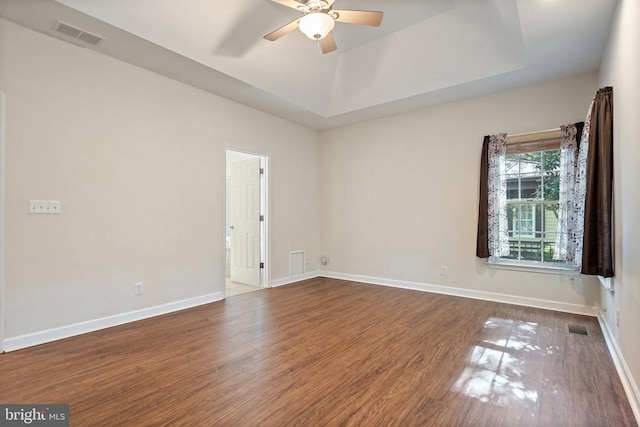 unfurnished room featuring wood finished floors, a ceiling fan, and baseboards