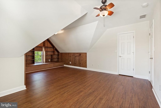 bonus room with baseboards, dark wood finished floors, a ceiling fan, and vaulted ceiling