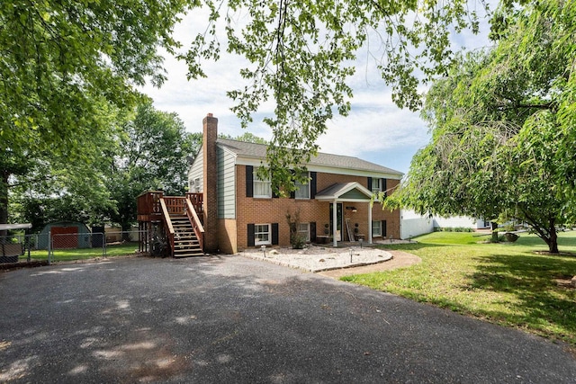 146 Harper St, Weyers Cave, VA 24486 - view of front facade with a chimney, stairs, brick siding, and driveway