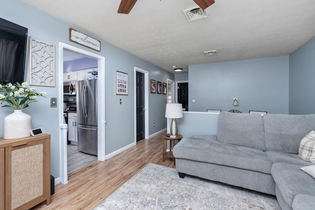 146 Harper St, Weyers Cave, VA 24486 - living room with ceiling fan, light wood-style flooring, and baseboards