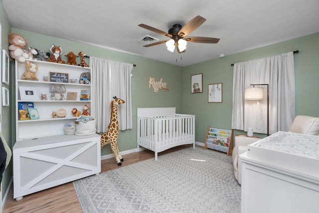146 Harper St, Weyers Cave, VA 24486 - bedroom with a nursery area, light wood finished floors, baseboards, and a ceiling fan