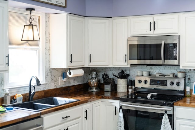 146 Harper St, Weyers Cave, VA 24486 - kitchen featuring stainless steel appliances, butcher block counters, a sink, white cabinetry, and backsplash
