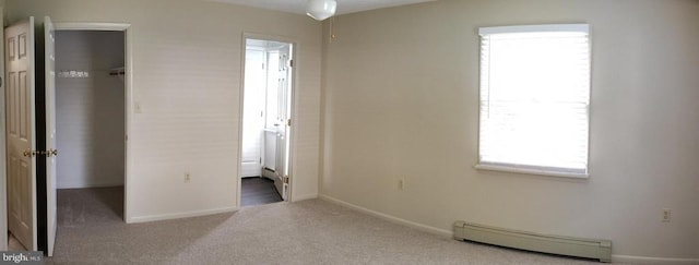 16 Park Ave, Luray, VA 22835 - unfurnished bedroom featuring a baseboard heating unit, a spacious closet, carpet, and a closet