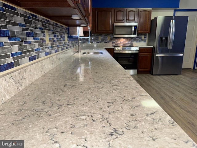 16 Park Ave, Luray, VA 22835 - kitchen with stainless steel appliances, tasteful backsplash, light stone counters, and wood finished floors