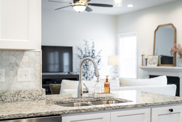 141 Tomasville Dr, Waynesboro, VA 22980 - kitchen featuring a sink, light stone counters, white cabinetry, and a ceiling fan