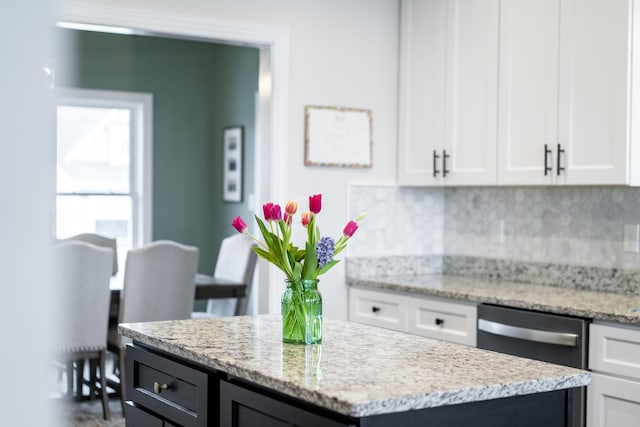 141 Tomasville Dr, Waynesboro, VA 22980 - kitchen featuring a center island, dishwasher, light stone counters, white cabinetry, and backsplash
