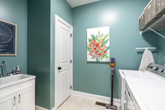 141 Tomasville Dr, Waynesboro, VA 22980 - laundry area with baseboards, washer and dryer, cabinet space, and a sink