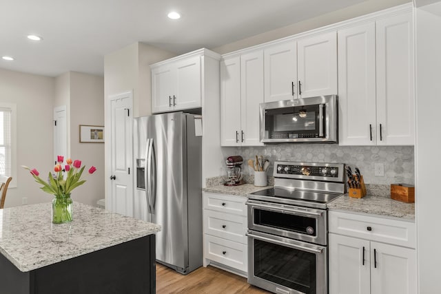 141 Tomasville Dr, Waynesboro, VA 22980 - kitchen featuring tasteful backsplash, recessed lighting, light wood finished floors, white cabinetry, and appliances with stainless steel finishes