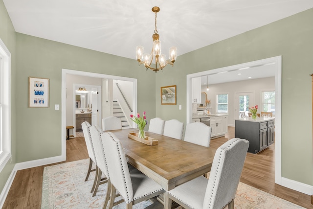 141 Tomasville Dr, Waynesboro, VA 22980 - dining space featuring light wood finished floors, a chandelier, baseboards, and stairs
