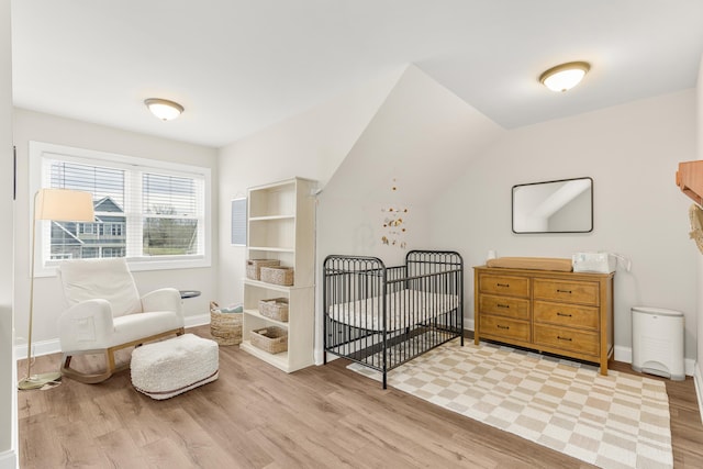 141 Tomasville Dr, Waynesboro, VA 22980 - bedroom with lofted ceiling, light wood-style flooring, baseboards, and a crib