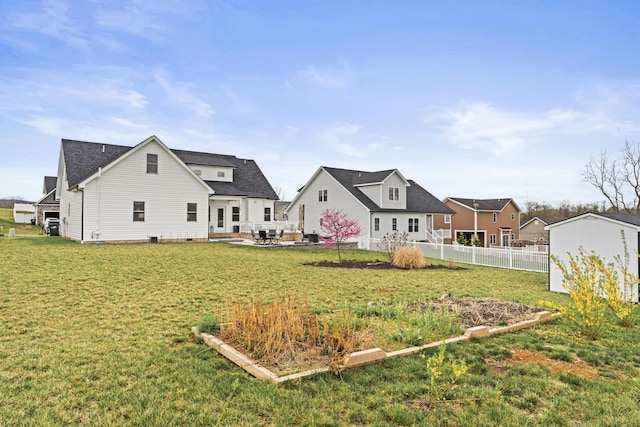 141 Tomasville Dr, Waynesboro, VA 22980 - back of house featuring a yard, a vegetable garden, fence, a patio area, and roof with shingles