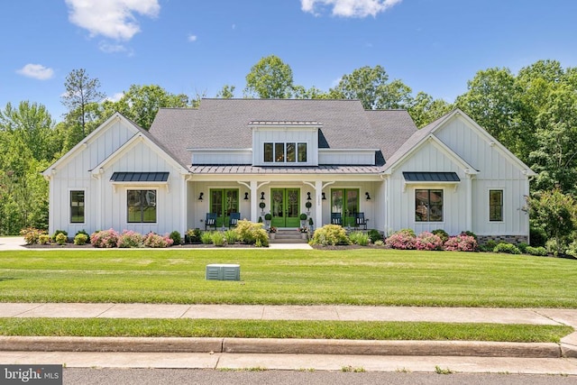 11206 Preswick Ln, Spotsylvania, VA 22551 - modern farmhouse with board and batten siding, covered porch, a standing seam roof, and a front lawn