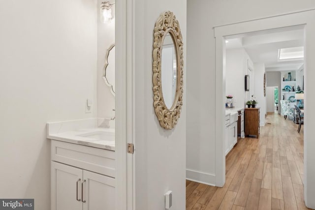 11206 Preswick Ln, Spotsylvania, VA 22551 - hallway with a sink, light wood-type flooring, and baseboards
