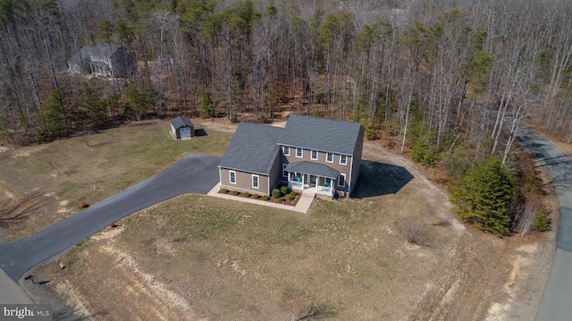 bird's eye view featuring a wooded view