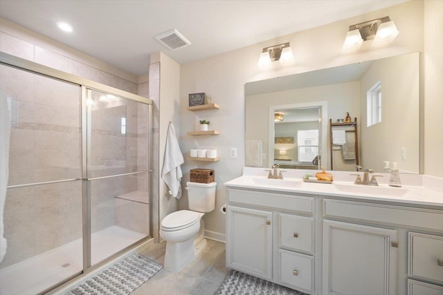 bathroom with an enclosed shower, vanity, and toilet