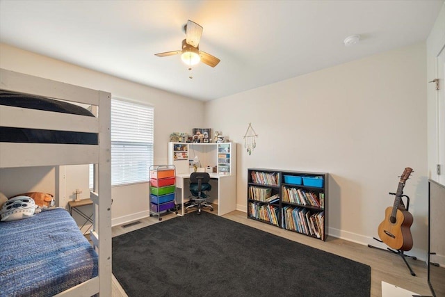 bedroom with ceiling fan and light hardwood / wood-style floors