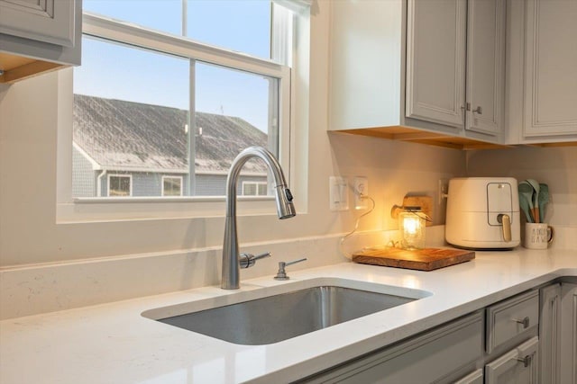 interior details featuring sink and gray cabinets