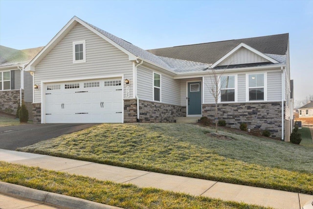 view of front of home featuring a garage and a front lawn