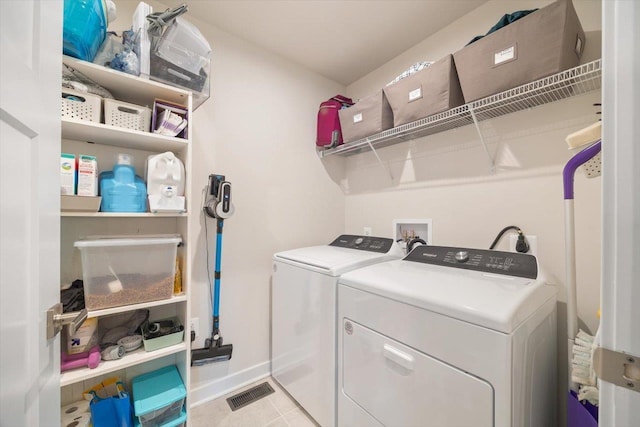 clothes washing area featuring washer and dryer