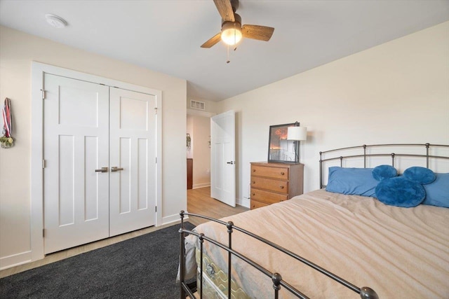 bedroom with ceiling fan and a closet