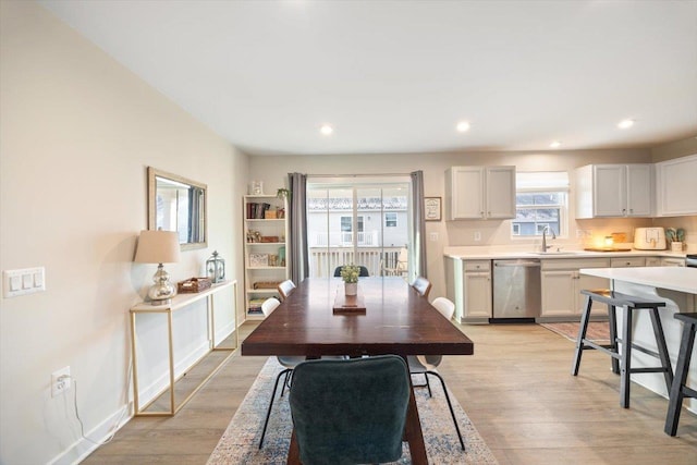 dining area featuring sink and light hardwood / wood-style flooring