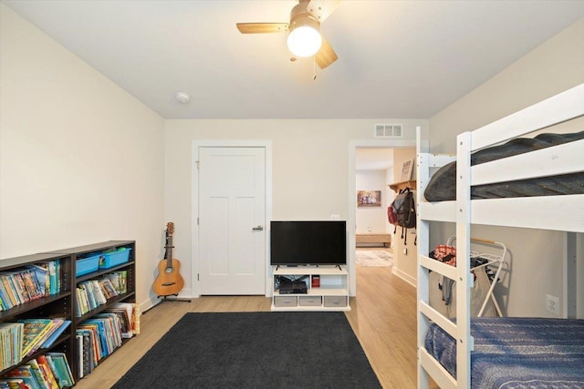 bedroom with light hardwood / wood-style floors and ceiling fan