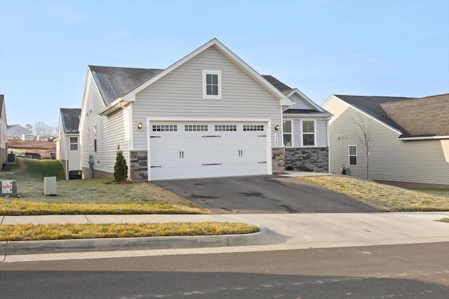 view of front of house with a garage and central air condition unit