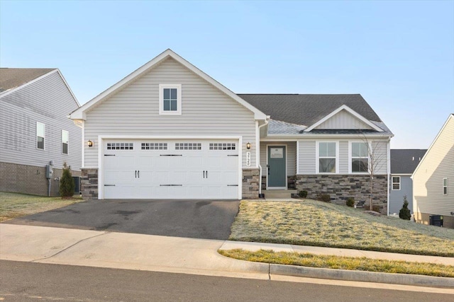 view of front of house featuring cooling unit and a garage