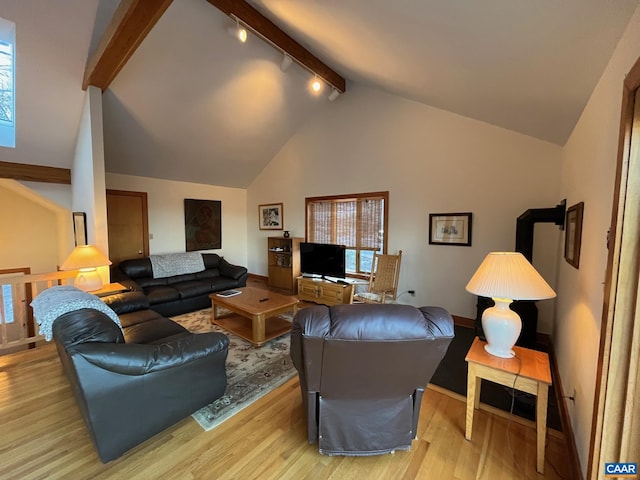 100 N Rock Tree Ln, Wintergreen Resort, VA 22967 - living room with beam ceiling, light wood finished floors, baseboards, rail lighting, and high vaulted ceiling