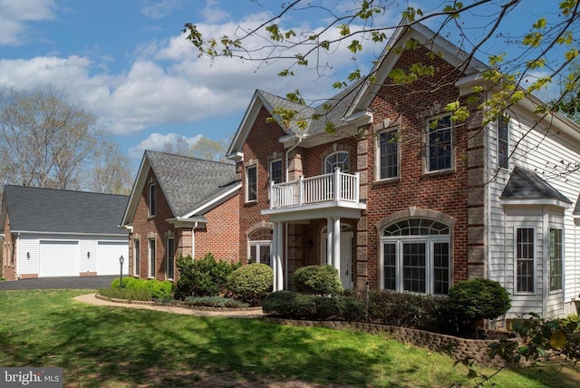 8800 General Griffins Ct, Fredericksburg, VA 22407 - view of front facade with a balcony, brick siding, a front yard, and a garage