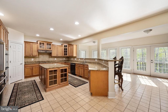 8800 General Griffins Ct, Fredericksburg, VA 22407 - kitchen featuring a peninsula, black dishwasher, a breakfast bar, a sink, and brown cabinets
