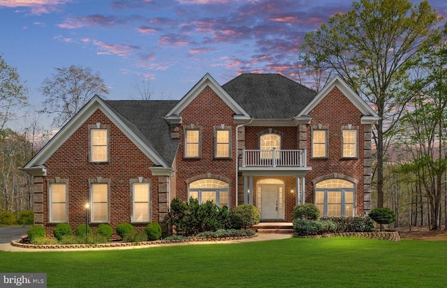 8800 General Griffins Ct, Fredericksburg, VA 22407 - colonial home featuring a balcony, brick siding, a lawn, and roof with shingles