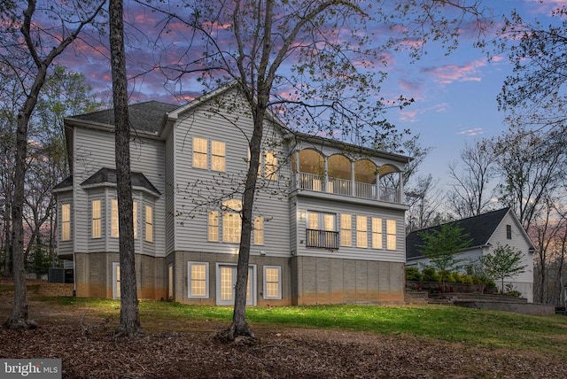 8800 General Griffins Ct, Fredericksburg, VA 22407 - back of house at dusk with a balcony and brick siding