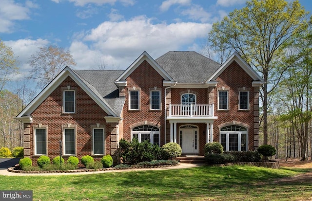 8800 General Griffins Ct, Fredericksburg, VA 22407 - colonial house featuring a balcony, brick siding, a front lawn, and roof with shingles