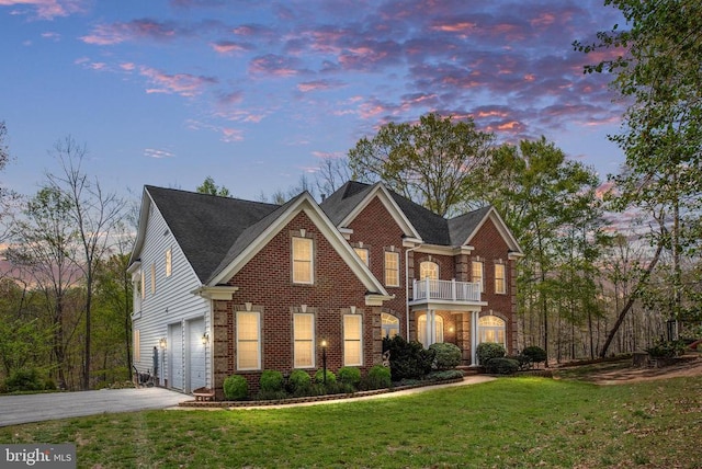 8800 General Griffins Ct, Fredericksburg, VA 22407 - colonial house featuring a balcony, driveway, an attached garage, brick siding, and a lawn