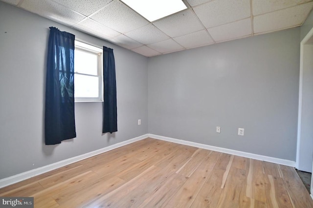 140 Wayland Dr, Stanley, VA 22851 - unfurnished room with baseboards, light wood-type flooring, and a paneled ceiling