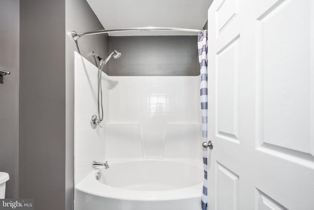 bathroom with shower / bath combo with shower curtain