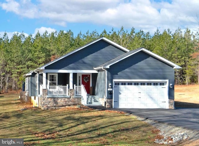 view of front of home with a porch, a garage, and a front yard