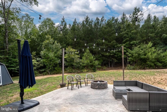 view of patio / terrace featuring an outdoor living space with a fire pit