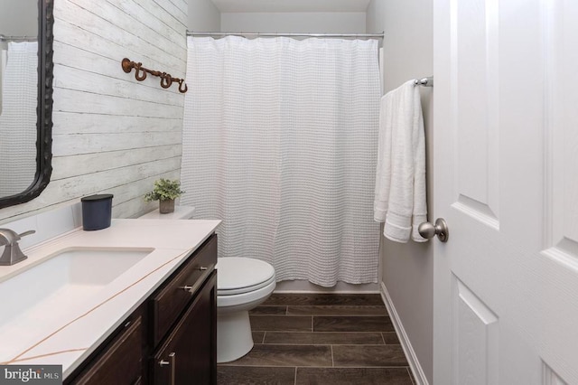 bathroom featuring vanity, a shower with shower curtain, and toilet