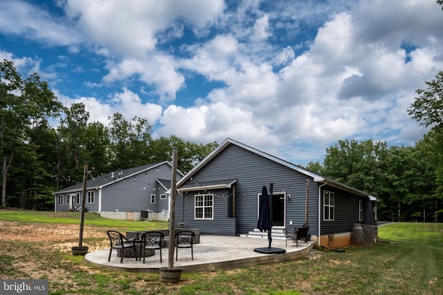 rear view of house featuring a patio and a lawn