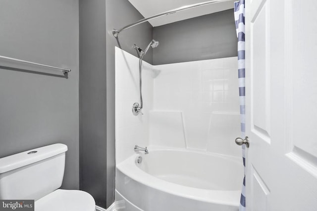 bathroom featuring shower / tub combo and toilet