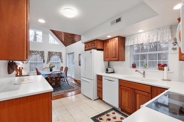 130 Rainier Rd, Mcgaheysville, VA 22840 - kitchen with white appliances, a sink, brown cabinets, light countertops, and lofted ceiling