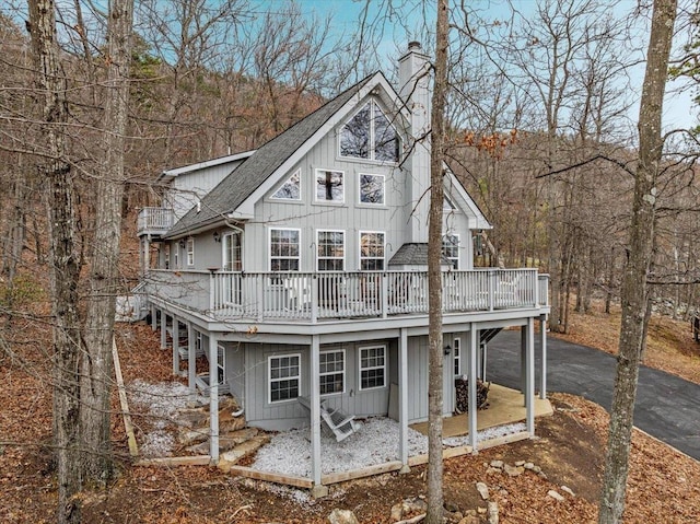 130 Rainier Rd, Mcgaheysville, VA 22840 - rear view of property featuring a chimney, a deck, board and batten siding, and a shingled roof