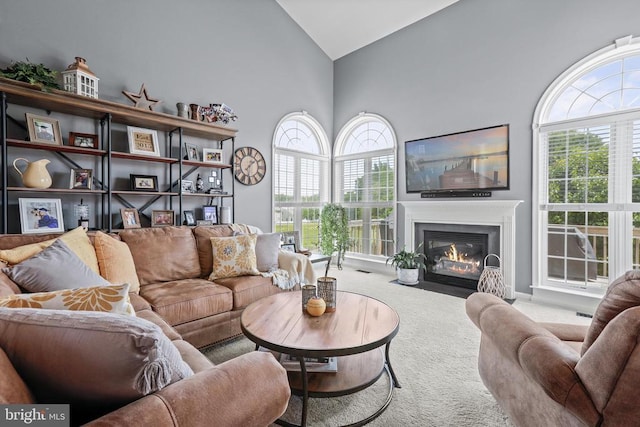 2609 Melissa Ct, Fredericksburg, VA 22408 - carpeted living room featuring high vaulted ceiling and a fireplace with flush hearth